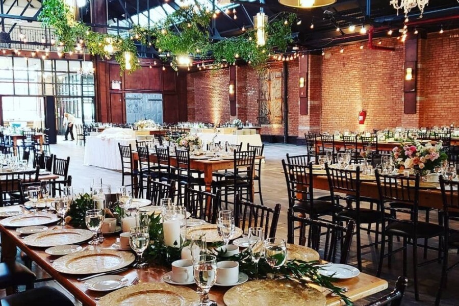 Industrial room with wedding tables decorated with flowers and candles
