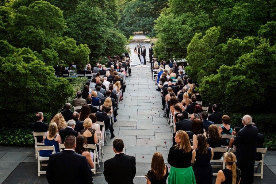 Bride and Groom getting married in front of guests outdoors