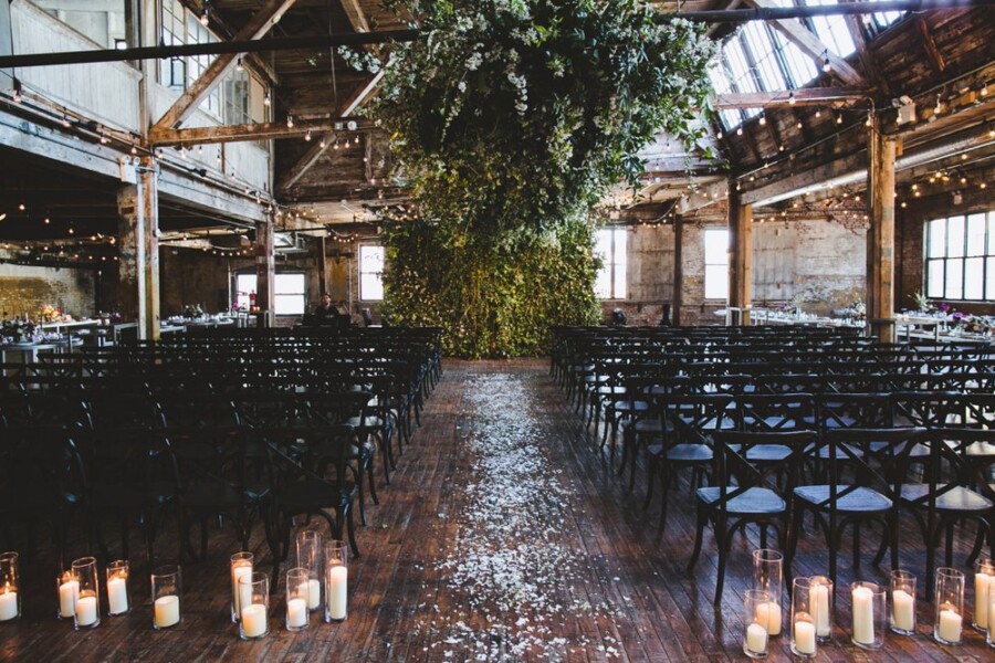 Rustic wedding venue with candles and wedding greenery