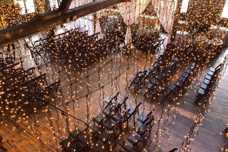 Wedding venue with string lights hanging above guests