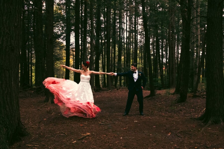 Bride and groom dancing in forest